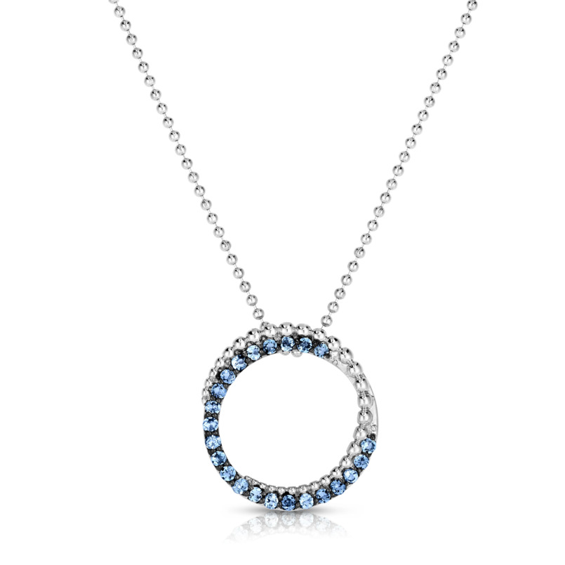 Sterling Silver Cutout Circle Pendant Having A Crescent Shape Of Round Cut Blue Topaz And A Beaded Accent Suspended On An 18 Inch Beaded Chain.