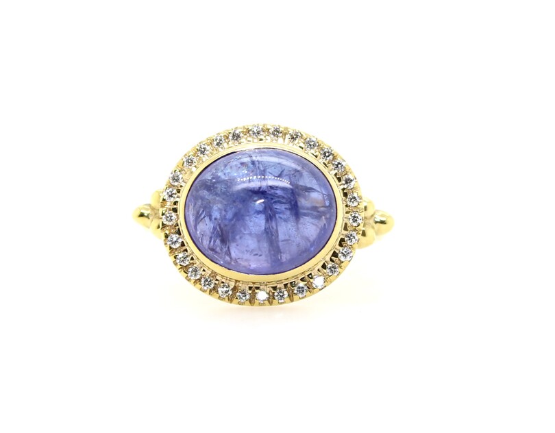 Mazza 14 Karat Yellow  Gold Tanzanite And Diamond Ring  Bezel Set In The Center Is 1 Oval Cabochon Cut Blue Sapphire Surrounded By 29 Full Cut Pave Set Diamonds With A Beaded Accent On Either Side