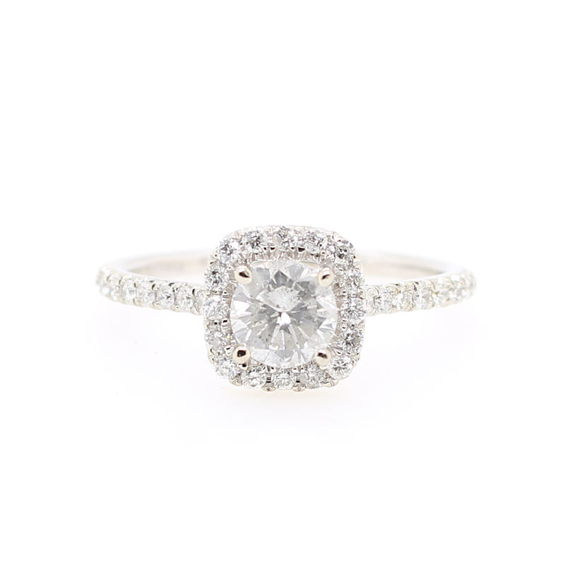 Lady's 14 karat white gold diamond ring having a round brilliant diamond 4 prong set in the center with a square halo design having 16 full cut prong set diamonds