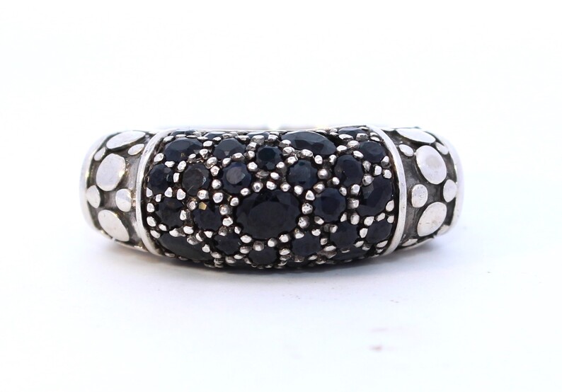 John Hardy Sterling Silver Black Sapphire Ring Having Oval & Round Cut Black Sapphires Prong Set In Center Section With Signature Armadillo Design On Either Side.