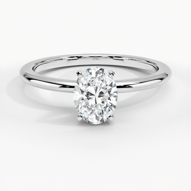 1 karat white gold diamond solitaire ring  Four prong set in the center is 1 oval cut diamond weighing .50 carat and graded I1  J.