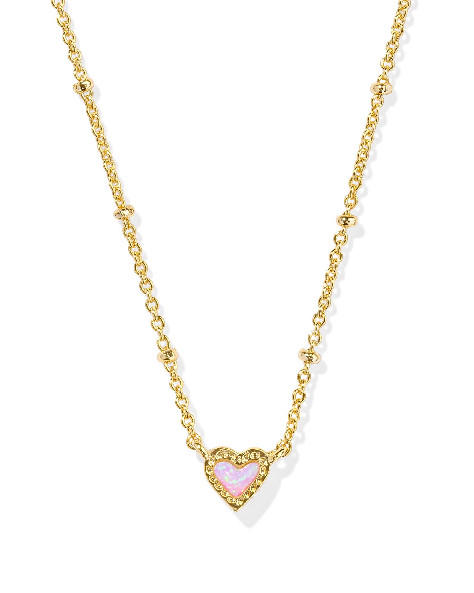 Kendra Scott Mini Ari heart satellite short pendant necklace featuring bubblegum pink kyocera opal framed in 14-karat yellow gold plated over brass on 19 inches. 0.35