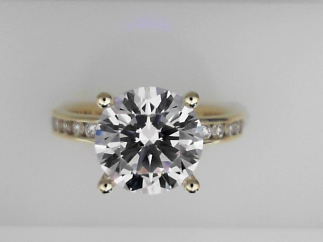 14K YELLOW GOLD FOUR PRONG SEMI MOUNTING WITH.44CTTW ROUND SI CLARITY & G COLOR DIAMONDS CHANNEL SET DOWN THE SHANK FOR A 2.5CT ROUND CENTER
