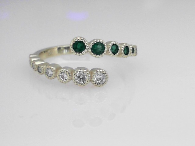 14K GREEN GOLD BYPASS RING WITH .25CTTW ROUND AND .20CTTW ROUND SI CLARITY & G COLOR DIAMONDS SET IN BEADED BEZELS
