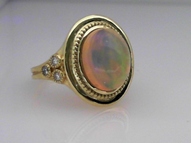 14K GREEN GOLD RING WITH A 2CT OVAL BEZEL SET OPAL WITH .18CTTW ROUND SI CLARITY & GH COLRO DIAMONDS SET ON THE SIDES