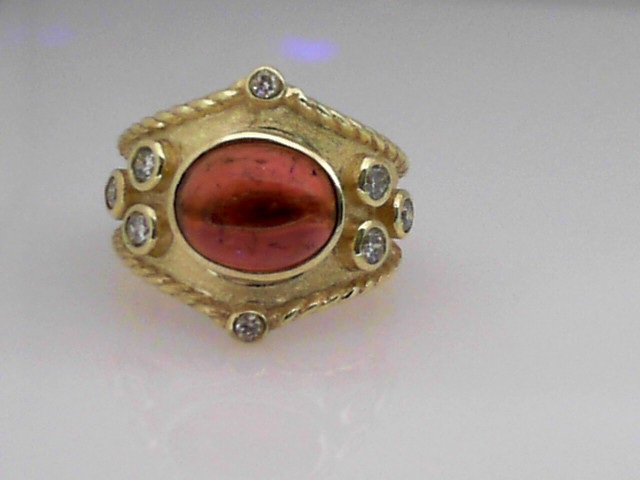 14K GREEN GOLD WIDE BAND WITH A 4CT PINK TOURMALINE CABOCHON AND .40CTTW ROUND BEZEL SET SI CLARITY & GH COLOR DIAMONDS