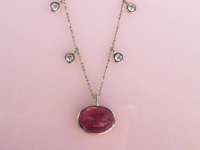 14K YELLOW GOLD CLEOPATRA STYLE NECKLACE WITH A 6CT OVAL PINK TOURMALINE CABOCHON WITH 6 ROUND BEZEL SET DIAMOND DANGLES ON A 16" DIAMOND CUT BEAD CHAIN