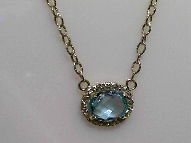 14K YELLOW GOLD TEXTURE LINK NECKALCE WITH A OVAL CHECKERBOARD CUT SKY BLUE TOPAZ WITH .22CTTW ROUND SI CLARITY & GH COLOR DIAMONDS SET IN THE HALO