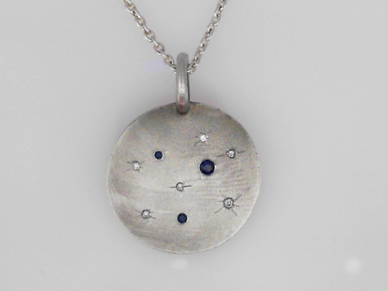 STERLING SILVER ROUND SATIN FINISH DISC CHARM WITH .06CTTW ROUND SAPPHIRES AND .03CTTW SI CLARITY & GH COLOR DIAMONDS ON A 1.5MM 16