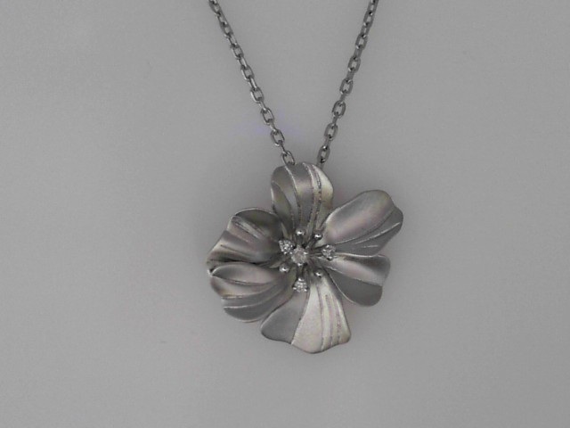 STERLING SILVER SATIN FINISH FLOWER PENDANT WITH .05CTTW ROUND DIAMONDS ON A 16/18